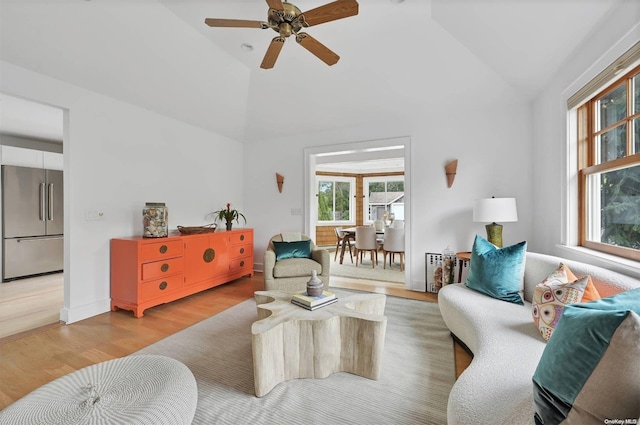 living room with wood-type flooring, radiator heating unit, high vaulted ceiling, and ceiling fan