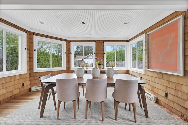 sunroom / solarium featuring a baseboard heating unit