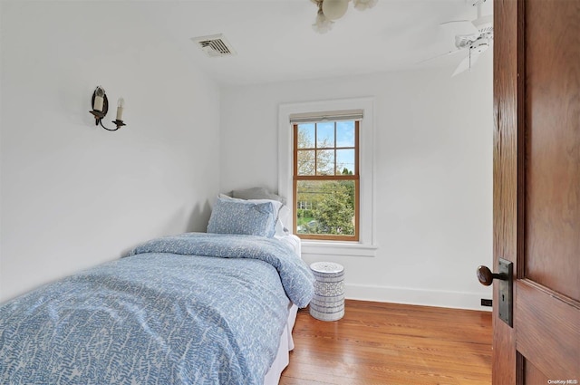 bedroom with hardwood / wood-style flooring and ceiling fan