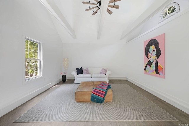 living room with vaulted ceiling with beams, ceiling fan, and hardwood / wood-style flooring