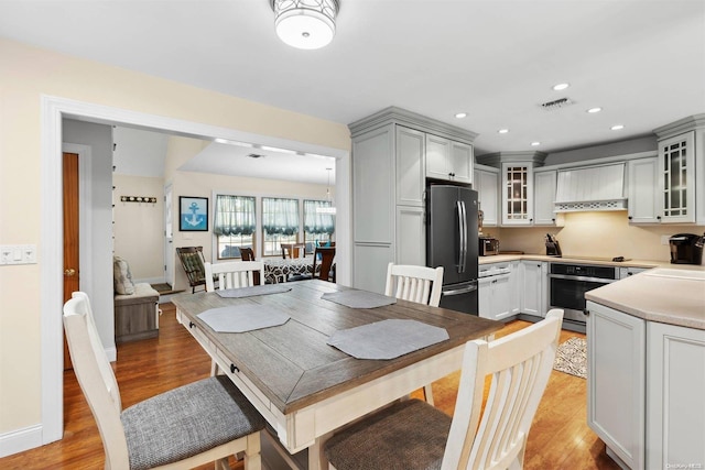 dining space with light hardwood / wood-style flooring