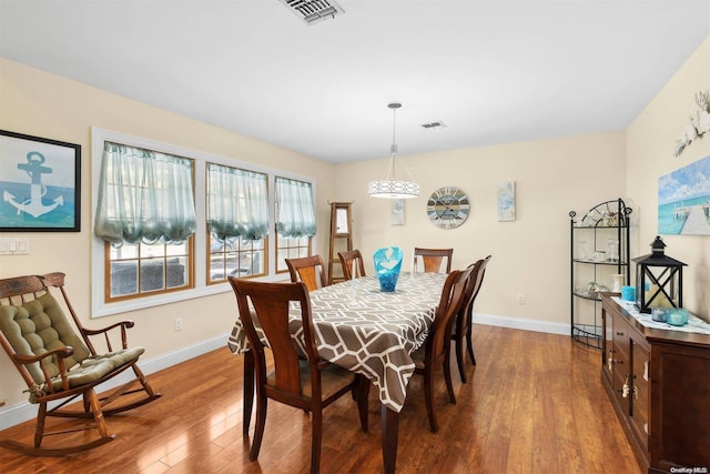 dining space with wood-type flooring