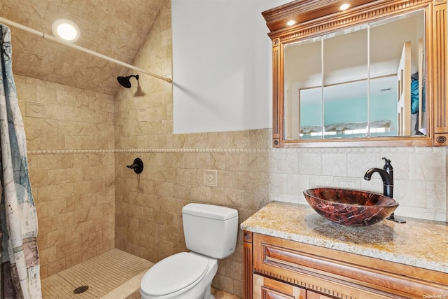 bathroom featuring vanity, toilet, tile walls, and curtained shower