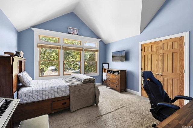 bedroom featuring lofted ceiling and light carpet