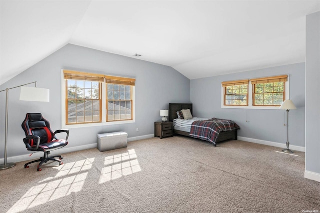 bedroom featuring carpet flooring, multiple windows, and lofted ceiling