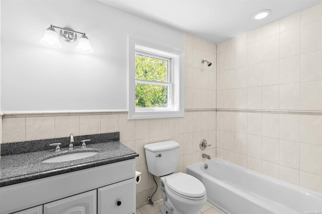 full bathroom featuring tile patterned floors, vanity, tile walls, and toilet