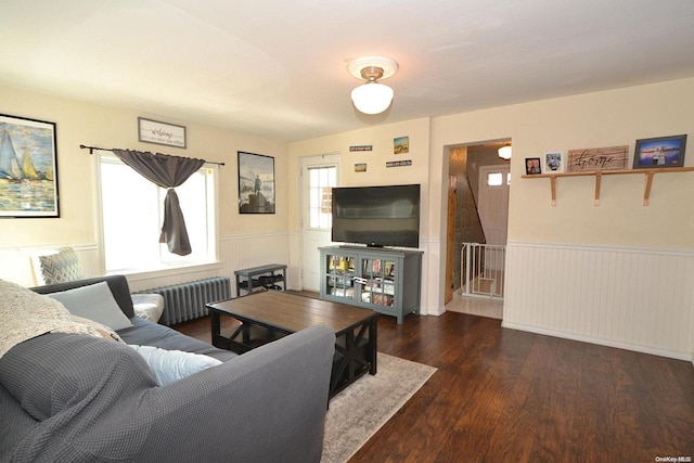 living room featuring radiator heating unit and dark wood-type flooring