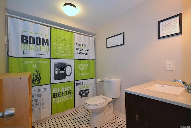 bathroom featuring tile patterned floors, walk in shower, vanity, and toilet