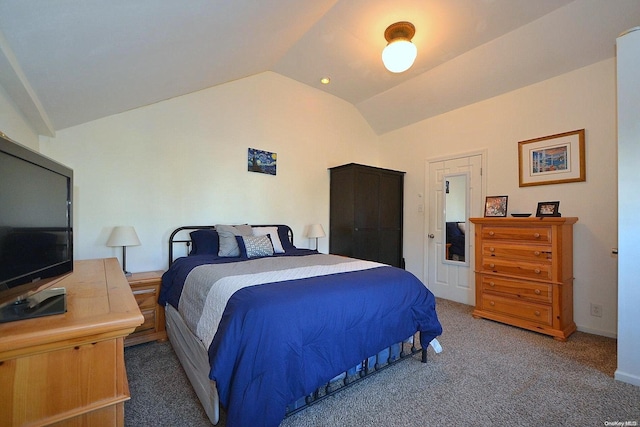 bedroom featuring dark colored carpet and lofted ceiling