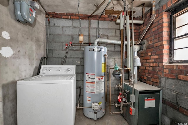 utility room with gas water heater and washer / dryer