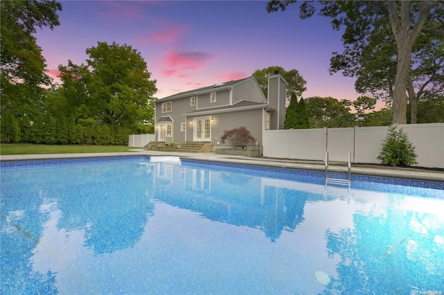 view of pool at dusk