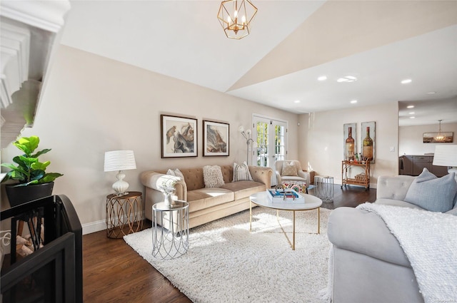 living room featuring dark wood-type flooring, vaulted ceiling, and an inviting chandelier