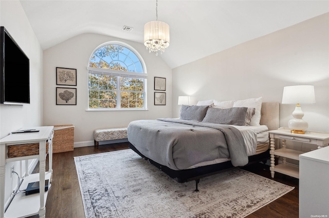 bedroom featuring a chandelier, dark wood-type flooring, and vaulted ceiling