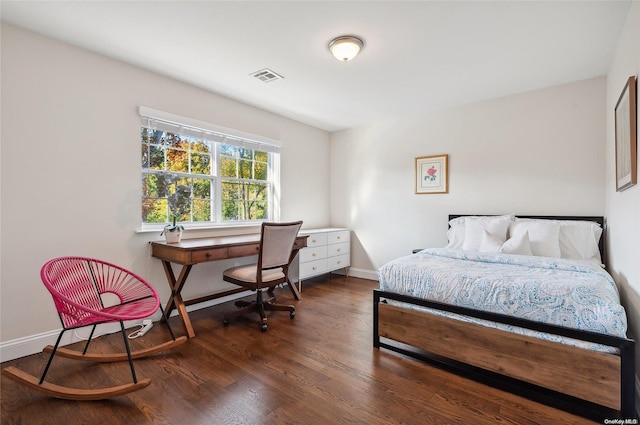 bedroom with dark hardwood / wood-style flooring