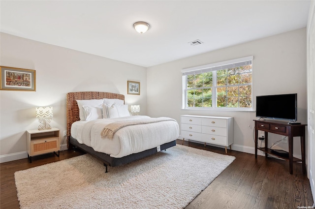 bedroom with dark wood-type flooring