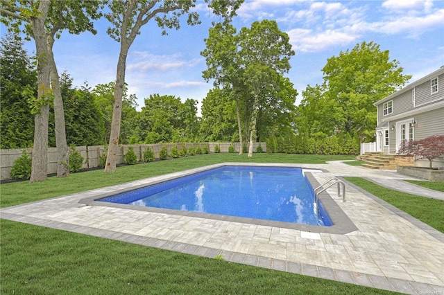 view of swimming pool with a yard and a patio