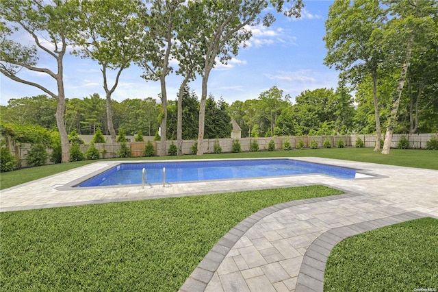 view of pool featuring a yard and a patio