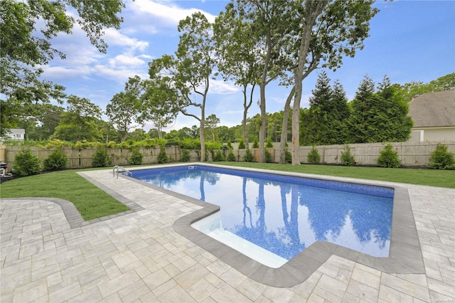 view of pool with a yard and a patio