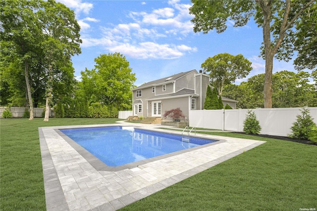 view of pool with a yard