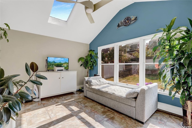 tiled living room with a skylight, high vaulted ceiling, and ceiling fan