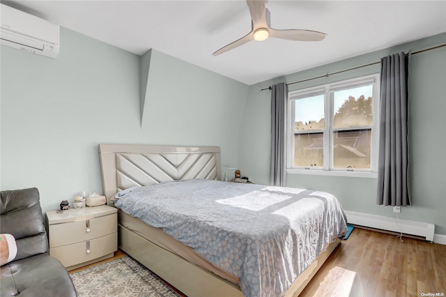 bedroom featuring baseboard heating, ceiling fan, an AC wall unit, and light wood-type flooring