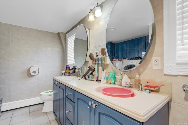 bathroom featuring toilet, tile walls, and a baseboard radiator