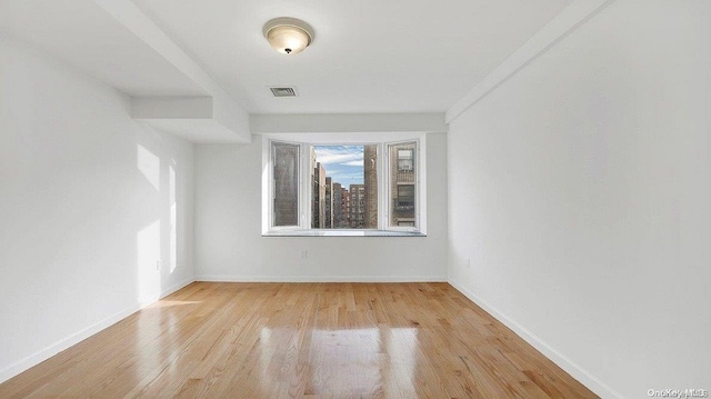 unfurnished room featuring light hardwood / wood-style floors