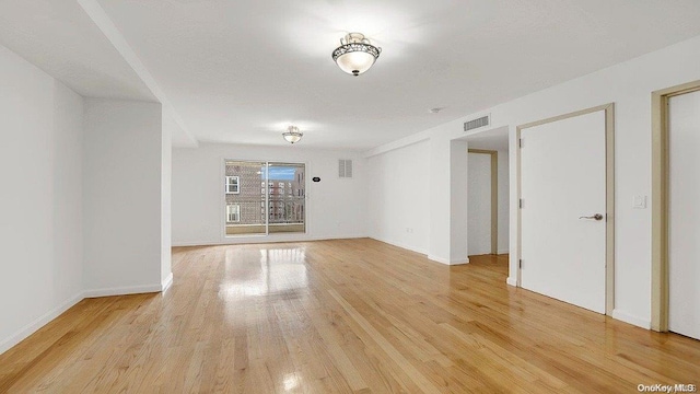 empty room with light hardwood / wood-style flooring