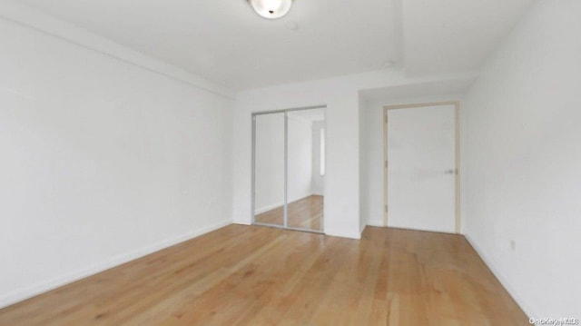 unfurnished bedroom with hardwood / wood-style floors