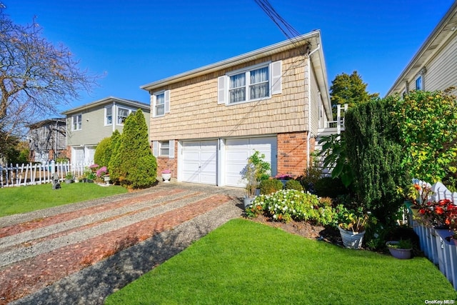 view of front of home with a garage and a front lawn