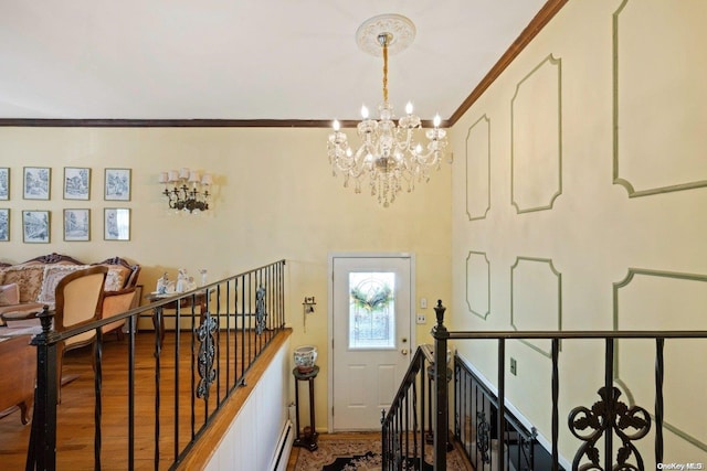 stairway with crown molding, an inviting chandelier, and hardwood / wood-style flooring