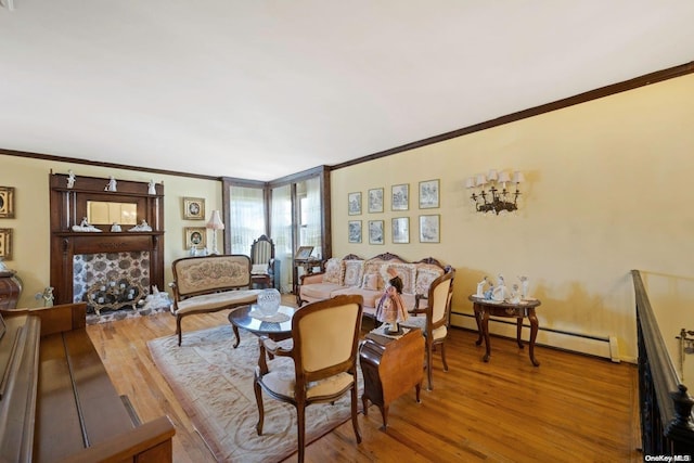 living room featuring crown molding, a baseboard radiator, and wood-type flooring