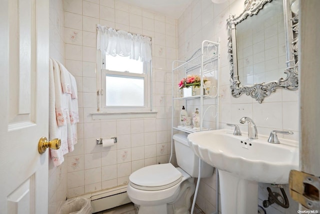 bathroom featuring toilet, tile walls, and a baseboard heating unit