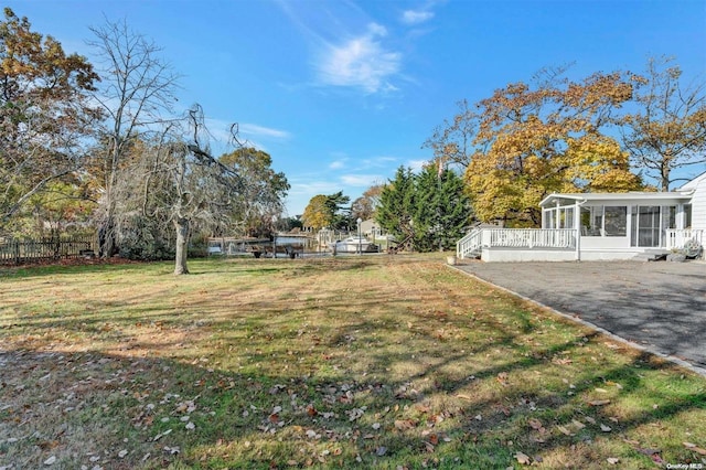 view of yard with a sunroom and a deck