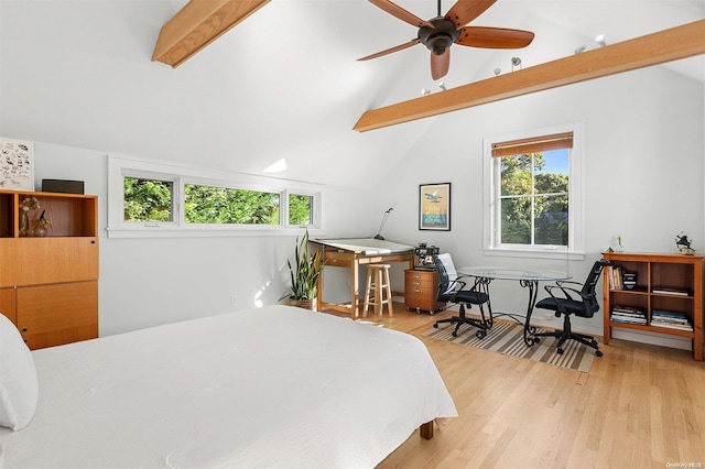 bedroom featuring multiple windows, lofted ceiling with beams, and light hardwood / wood-style floors