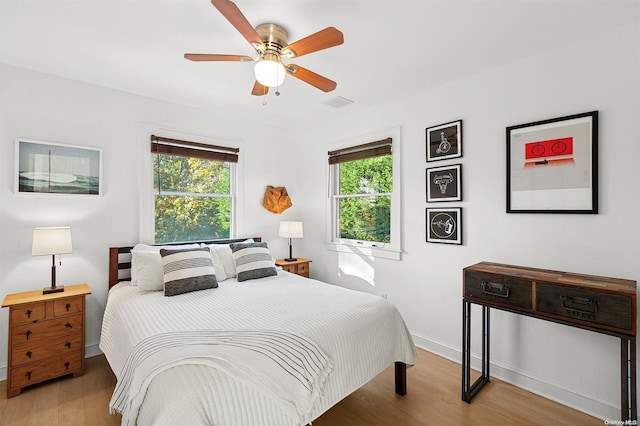 bedroom with ceiling fan and light hardwood / wood-style floors