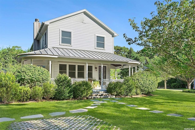 view of front facade with a front lawn and covered porch