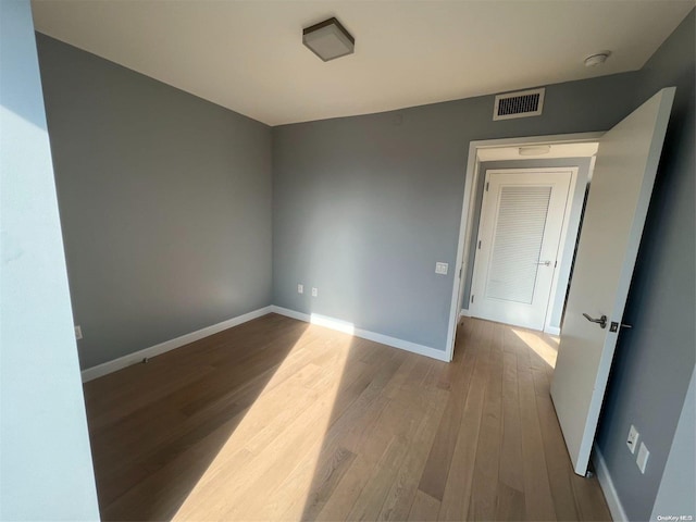 unfurnished room with light hardwood / wood-style flooring