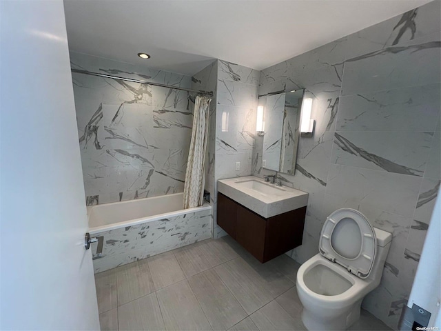 bathroom with vanity, shower / bathtub combination with curtain, and tile walls