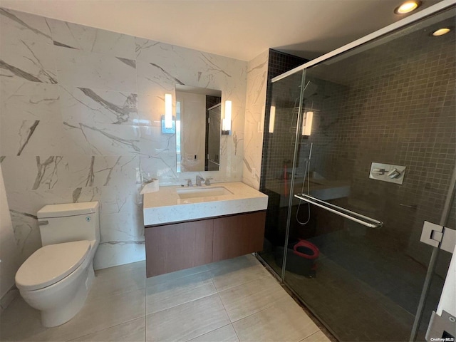 bathroom featuring an enclosed shower, vanity, toilet, and tile walls