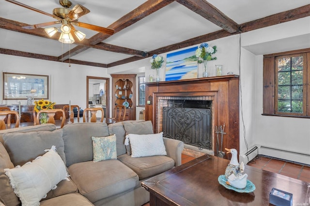 tiled living room with beamed ceiling, a baseboard heating unit, ceiling fan, and a fireplace