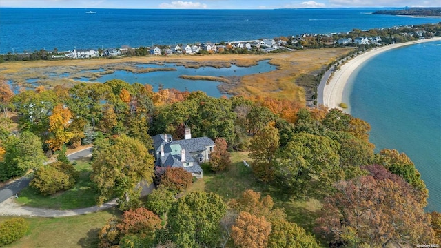 birds eye view of property with a water view and a view of the beach