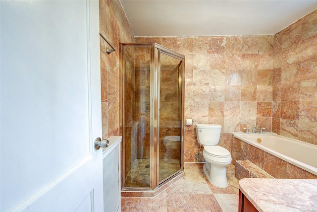 full bathroom featuring vanity, toilet, shower with separate bathtub, and tile walls