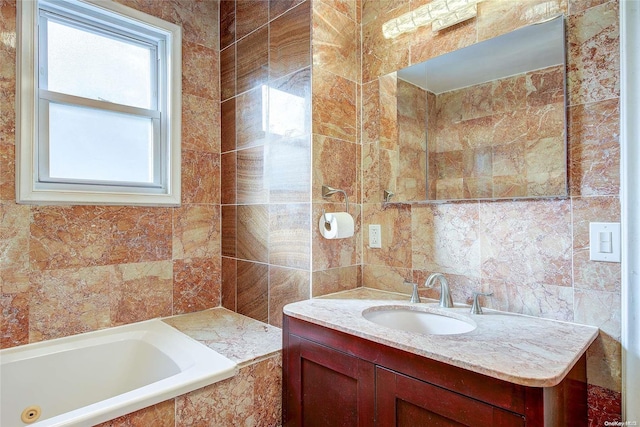 bathroom with a relaxing tiled tub, tile walls, and vanity