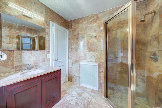 bathroom with vanity, tile walls, and walk in shower