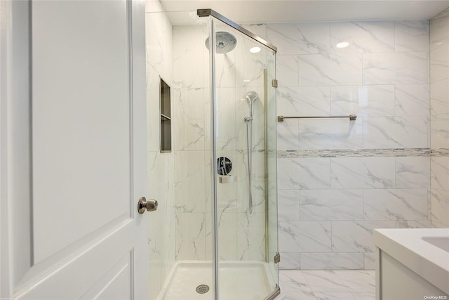 bathroom with vanity and a shower with shower door