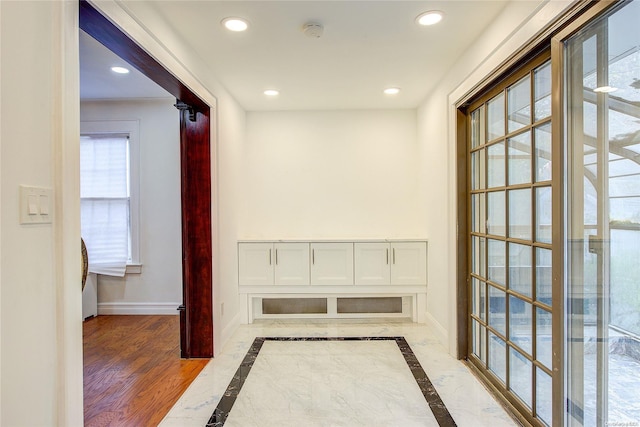 hallway with hardwood / wood-style floors