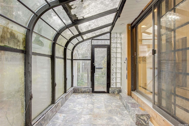 unfurnished sunroom with vaulted ceiling