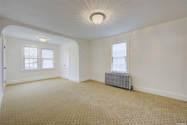 carpeted spare room with radiator