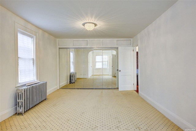 interior space with radiator heating unit and a healthy amount of sunlight